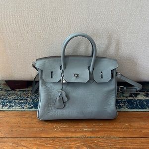 Leather “Kelly” bag style purse.